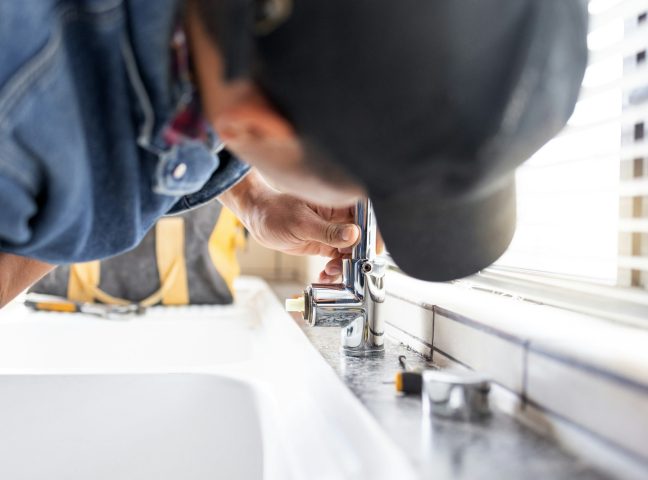 Plumber fixing faucet, plumbing and maintenance with man, manual labour and home renovation with tr Plumber fixing faucet, plumbing and maintenance with man, manual labour and home renovation with tr