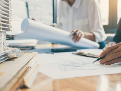 Team of Construction engineering or architect hands working on blueprint inspection in workplace Team of Construction engineering or architect hands working on blueprint inspection in workplace